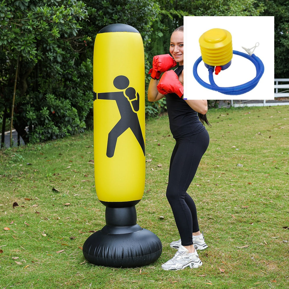 Woman boxing with the yellow Fitness Sandbag punching bag outdoors