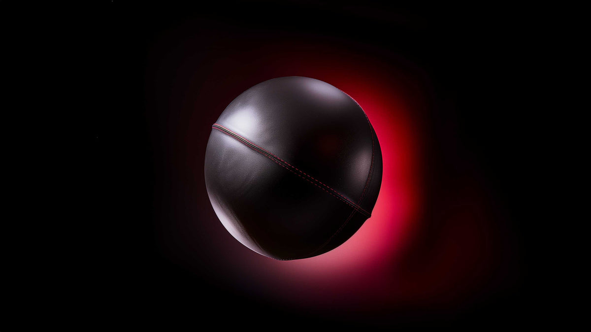 Medicine ball on dark background with red glow — Young Blood